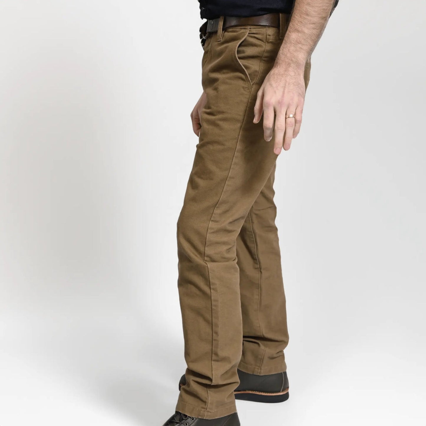 Durable brown colored canvas pants with a timeless classic design, offering a structured fit that fades over time like denim for a unique, worn-in look.