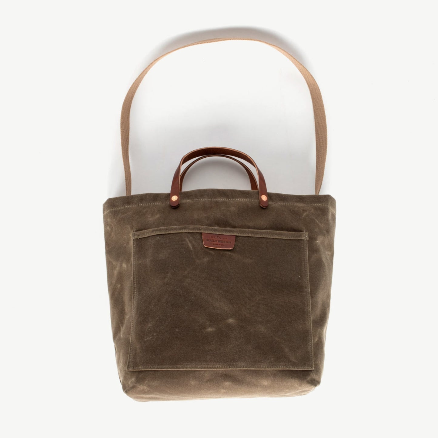 Sturdy waxed duck canvas tote bag with a rugged, featuring comfortable handles and a spacious interior for everyday use.