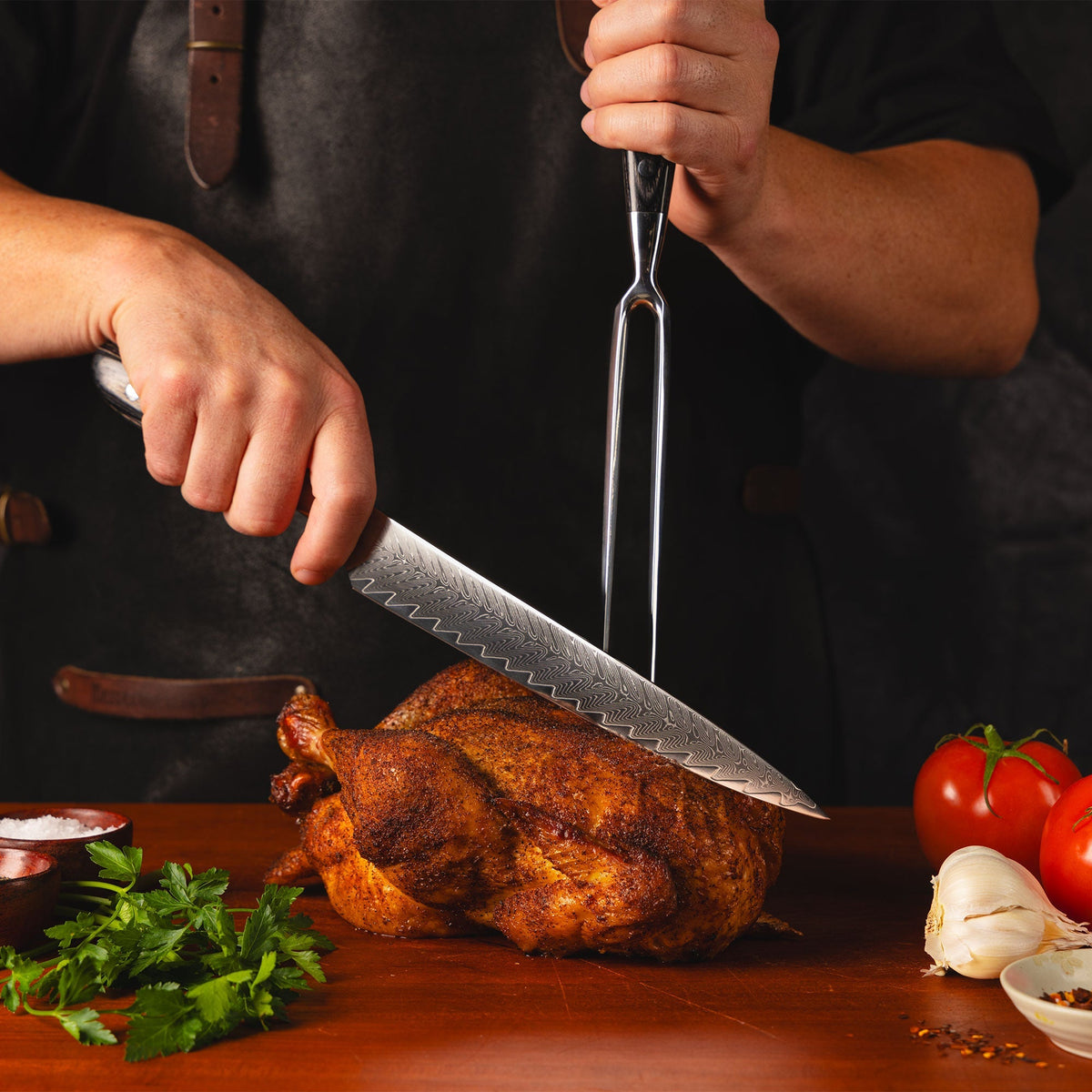 Avanta Damascus knife set in use while carving a roast chicken