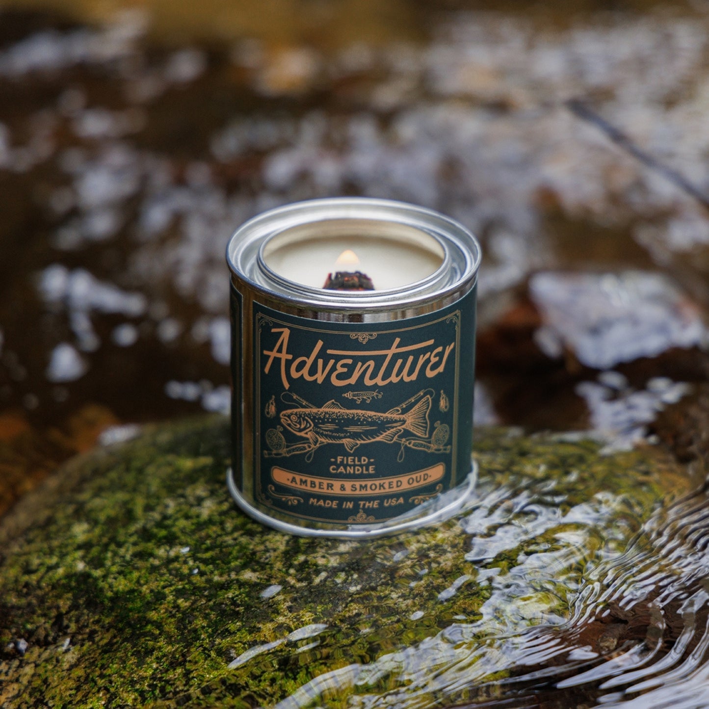 Amber & smokey scented soy candle in a sleek container, showcasing its warm, inviting glow.