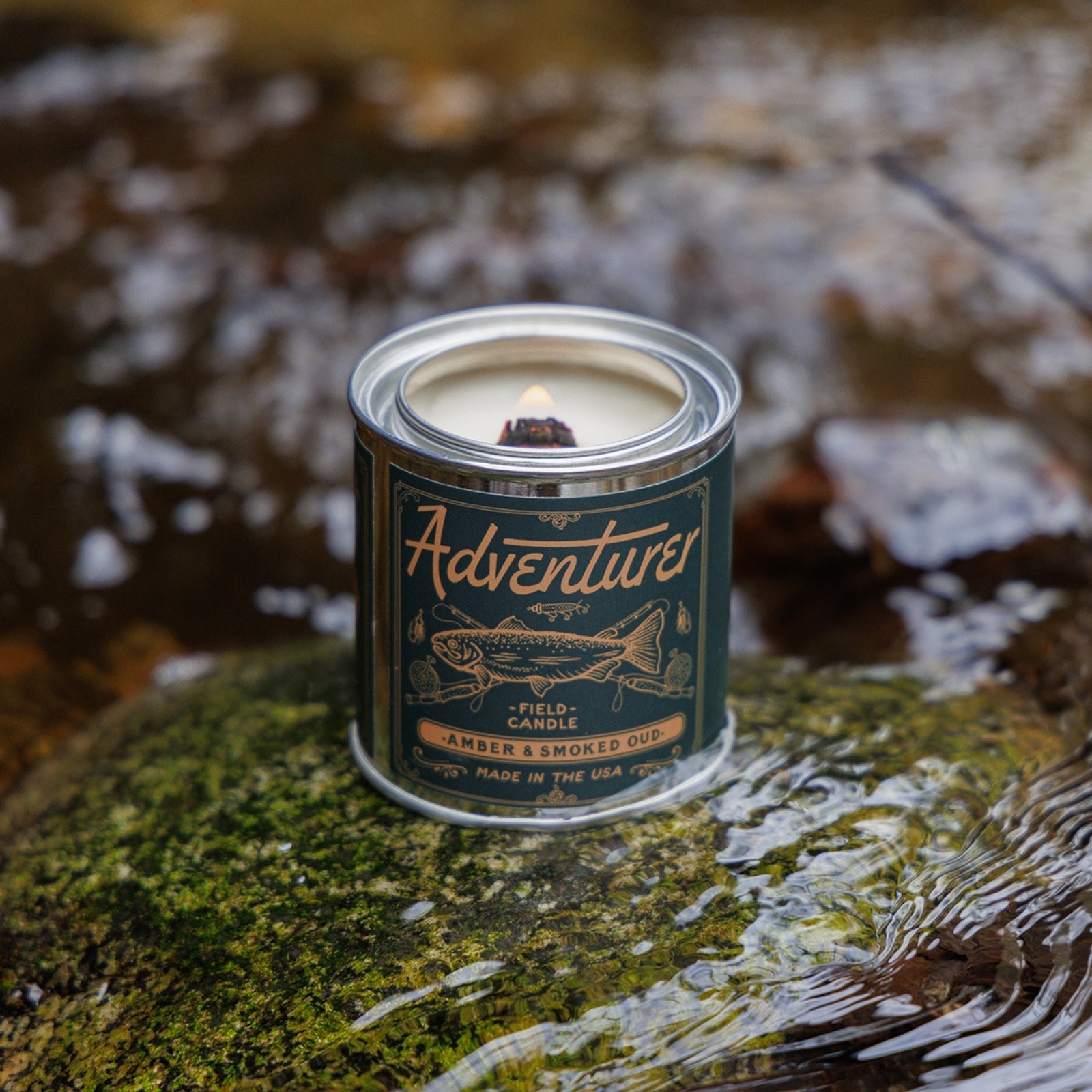 Amber & smokey scented soy candle in a sleek container, showcasing its warm, inviting glow.