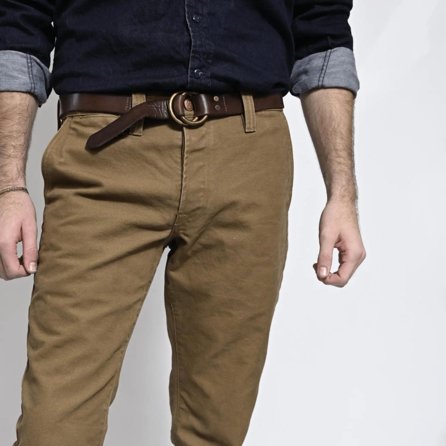 Durable brown colored canvas pants with a timeless classic design, offering a structured fit that fades over time like denim for a unique, worn-in look.