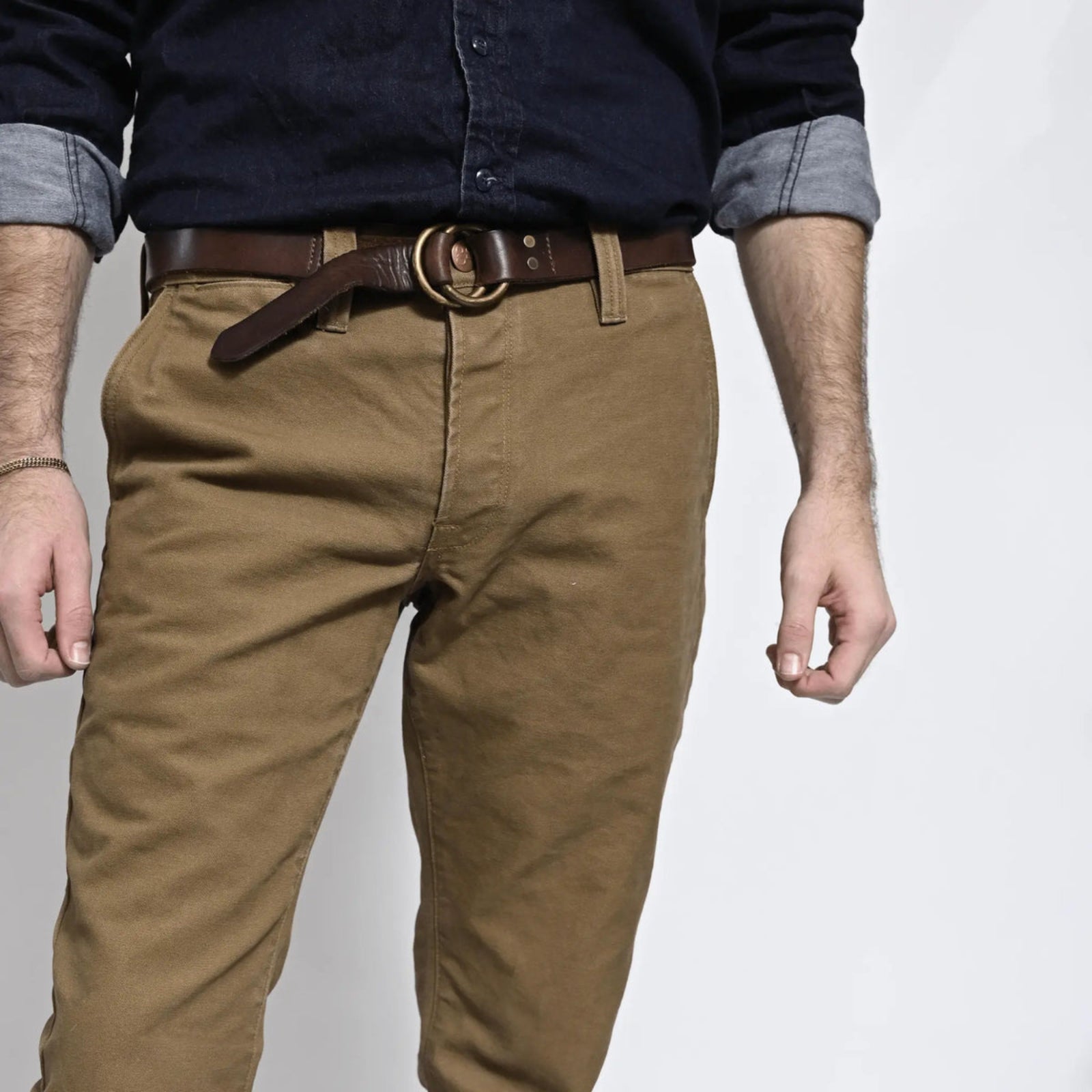 Durable brown colored canvas pants with a timeless classic design, offering a structured fit that fades over time like denim for a unique, worn-in look.
