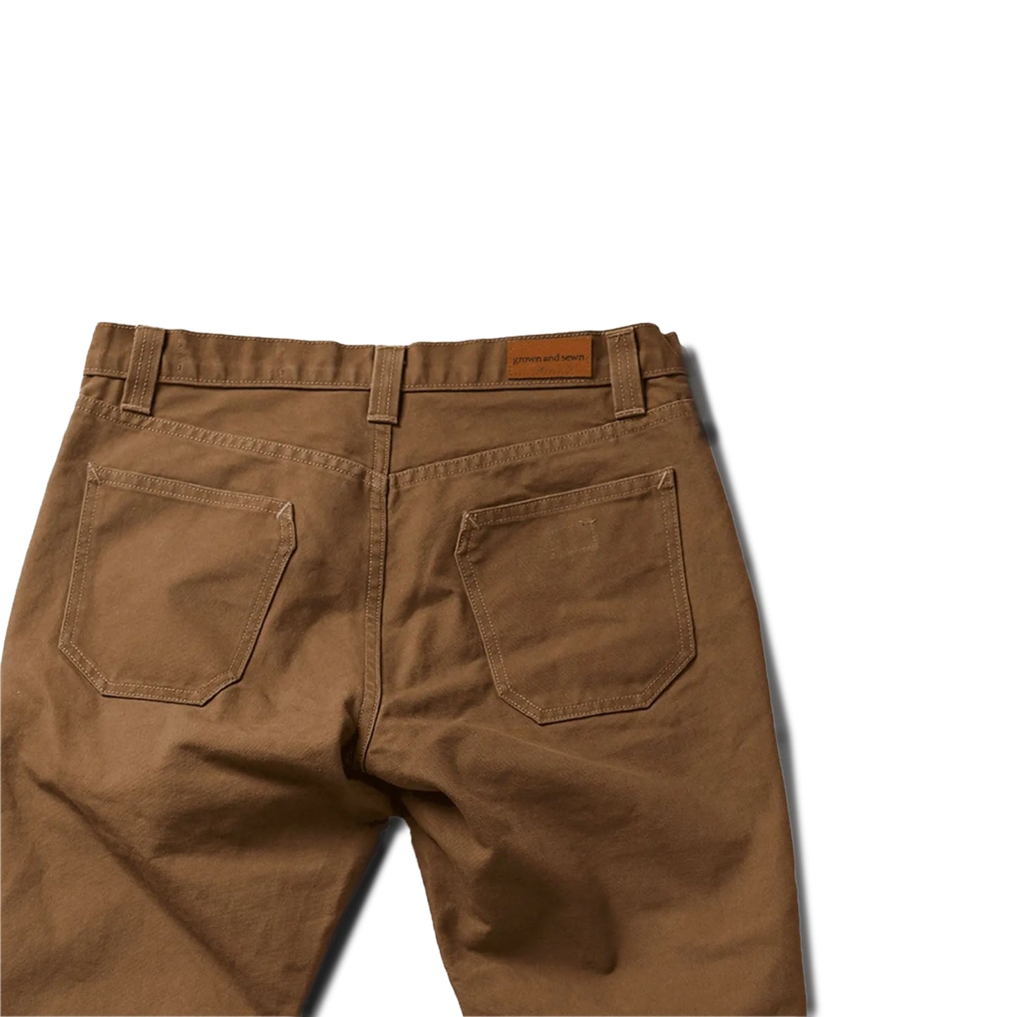 Durable brown colored canvas pants with a timeless classic design, offering a structured fit that fades over time like denim for a unique, worn-in look.