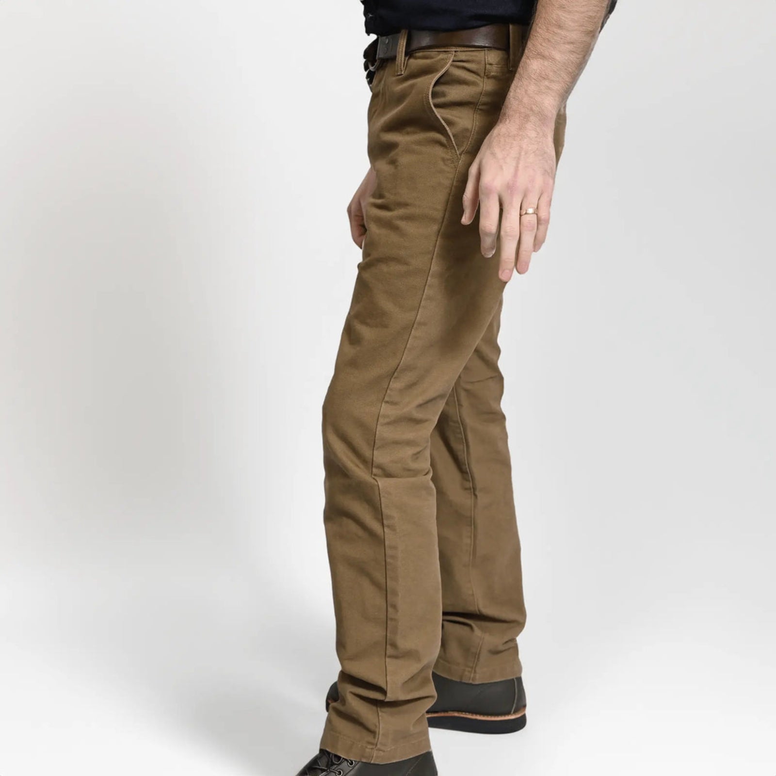 Durable brown colored canvas pants with a timeless classic design, offering a structured fit that fades over time like denim for a unique, worn-in look.