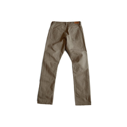 Durable green colored canvas pants with a timeless classic design, offering a structured fit that fades over time like denim for a unique, worn-in look.