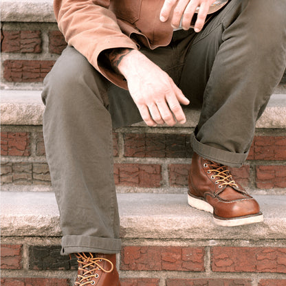 Durable green colored canvas pants with a timeless classic design, offering a structured fit that fades over time like denim for a unique, worn-in look.