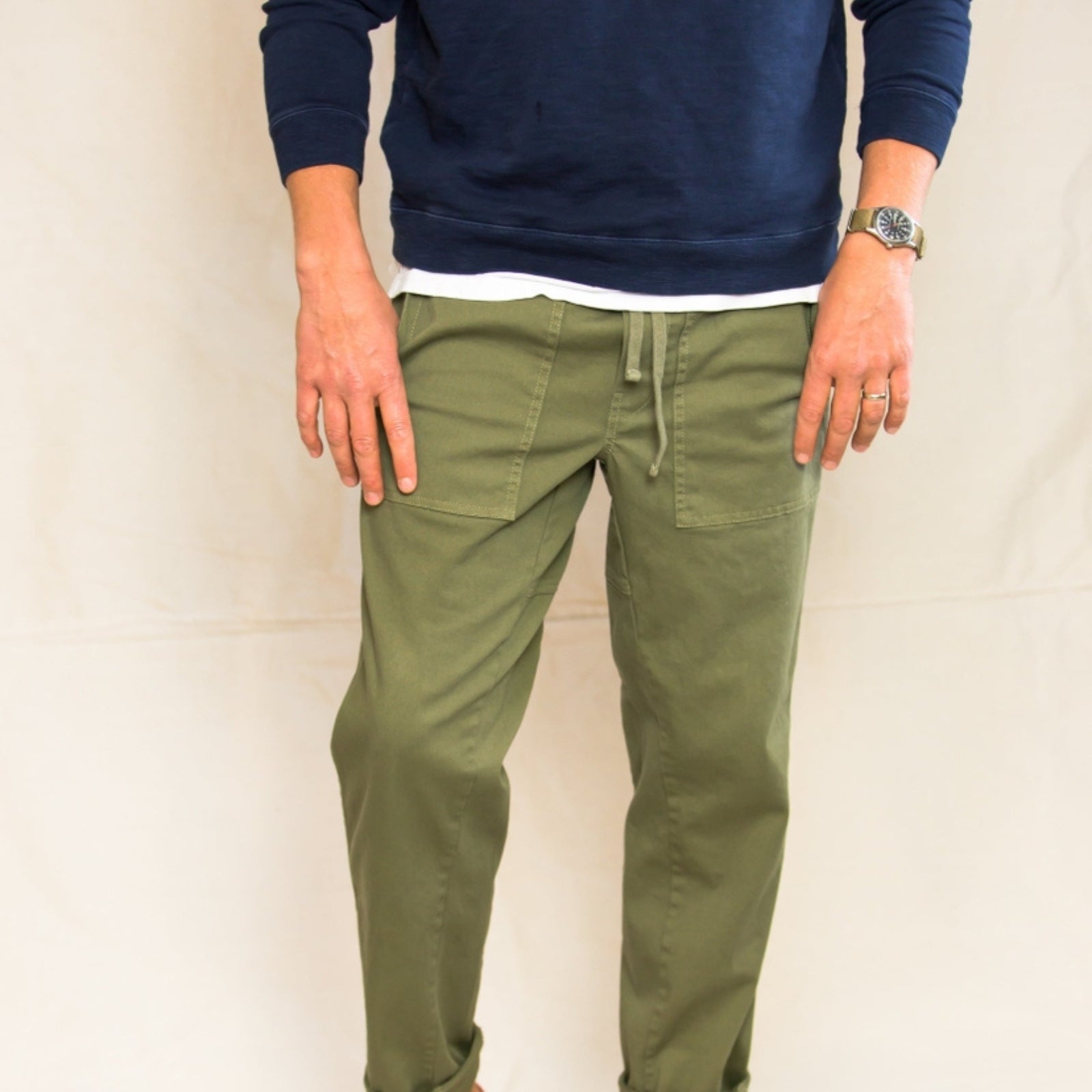 Men's green cargo pants with multiple pockets and a relaxed fit.