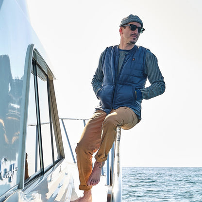 Lifestyle shot of a navy blue down vest that showcases the texture and warmth.