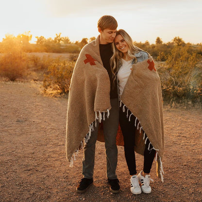 Handwoven throw blanket with intricate patterns, showcasing its cozy texture and warm colors.