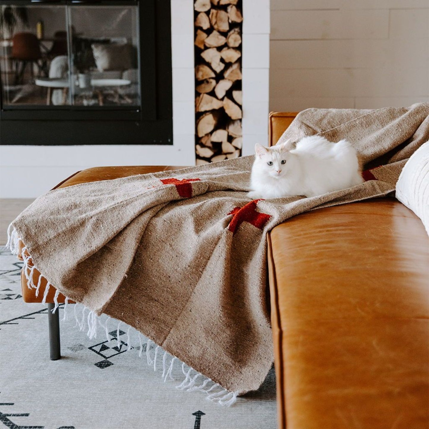 Handwoven throw blanket with intricate patterns, showcasing its cozy texture and warm colors.