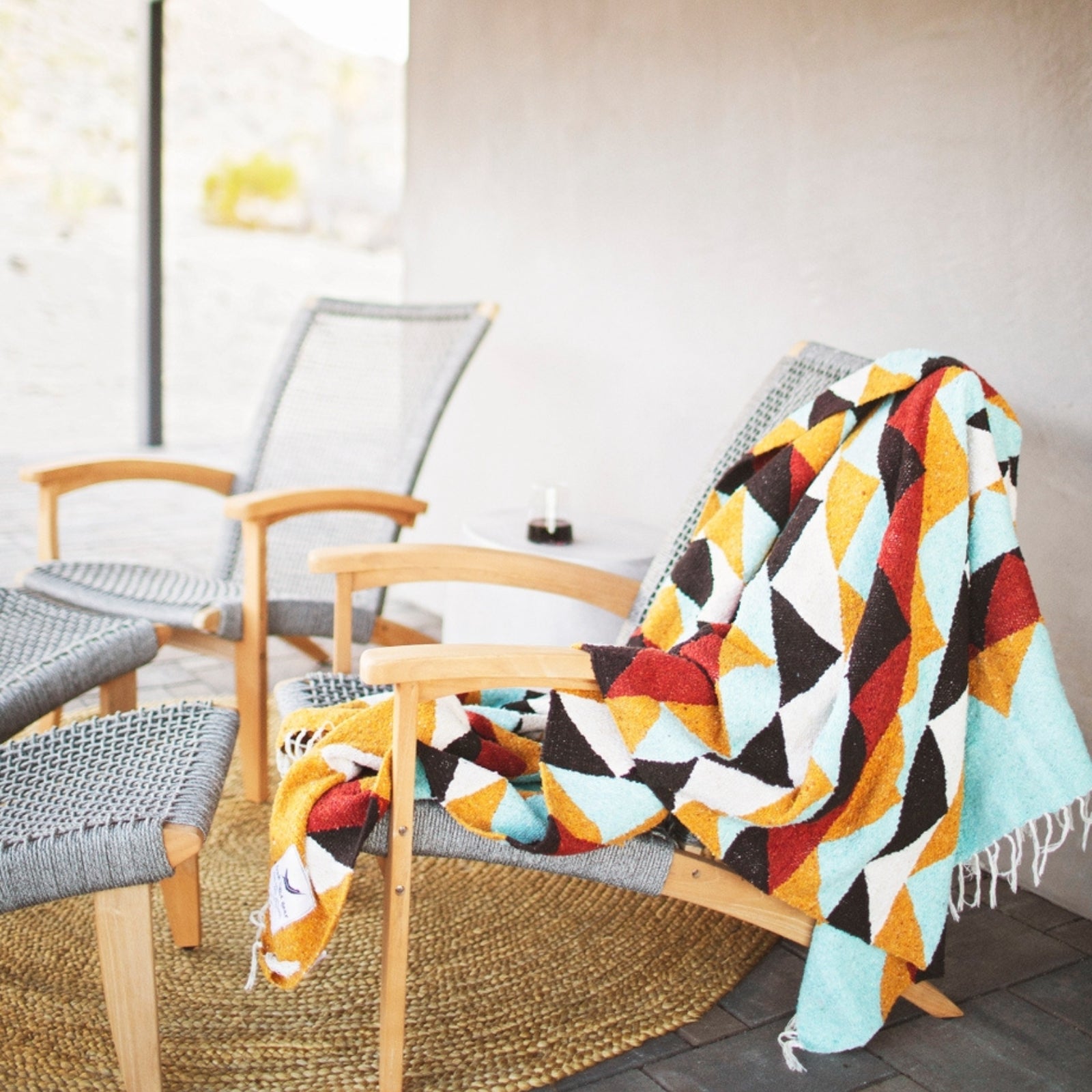 Handwoven throw blanket with intricate patterns, showcasing its cozy texture and warm colors.
