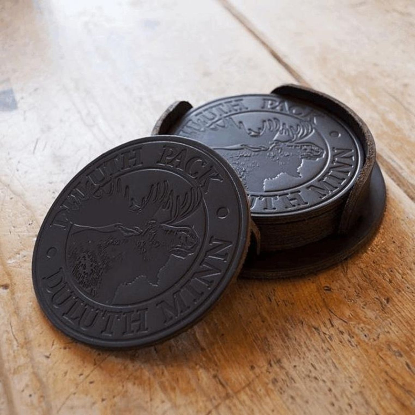 Durable leather coaster with smooth finish, perfect for protecting surfaces and adding a stylish touch to home or office decor.