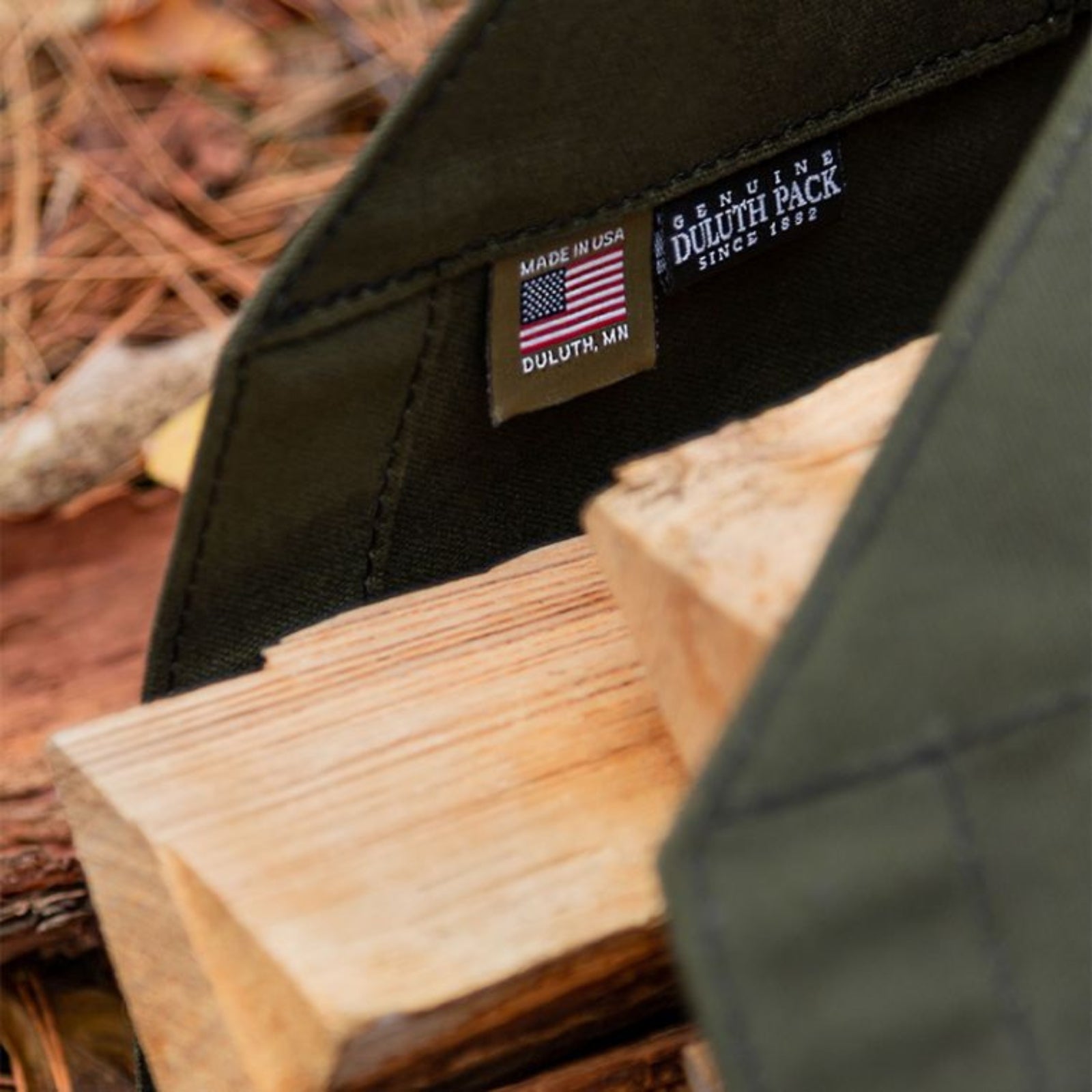 Durable log carrier made of heavy-duty fabric, designed for easily transporting firewood with sturdy handles for added convenience.