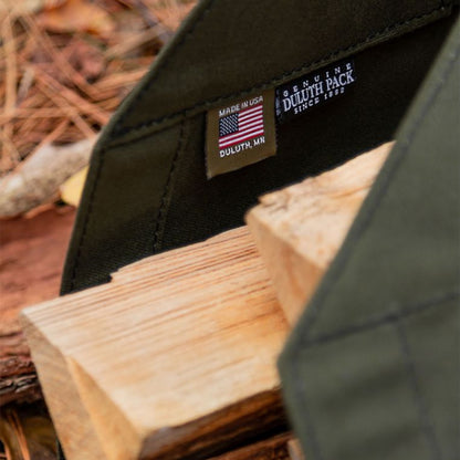 Durable log carrier made of heavy-duty fabric, designed for easily transporting firewood with sturdy handles for added convenience.