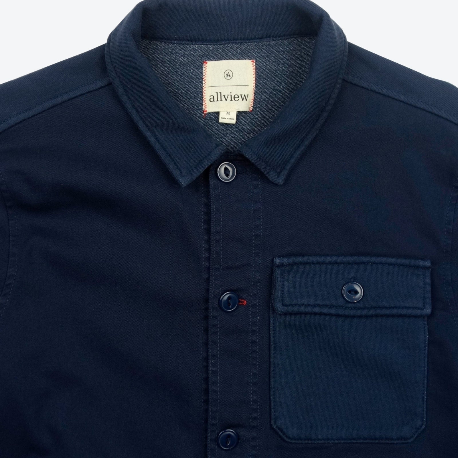 Navy blue button-down jacket with three pockets, casual outerwear for men.
