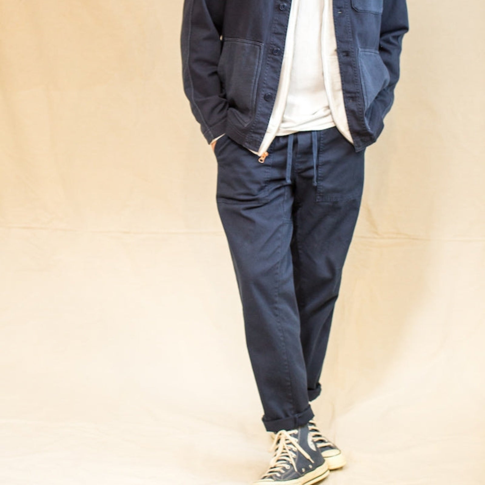 Men's navy pants with multiple pockets and a relaxed fit.