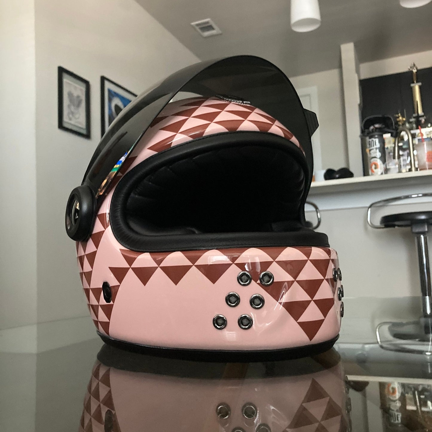 Retro Polynesian-inspired motorcycle helmet with bold tribal designs and vibrant colors, perfect for riders seeking unique style and protection.