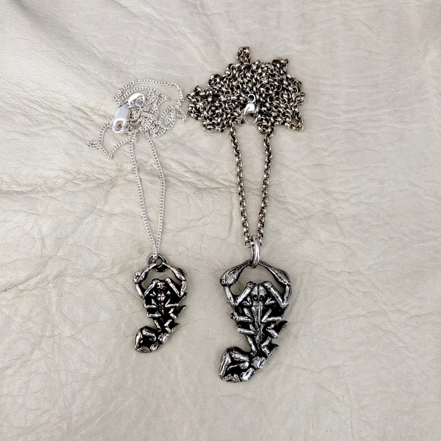 Intricate scorpion ring with detailed design, featuring a sleek matte look with a rounded smooth finish.