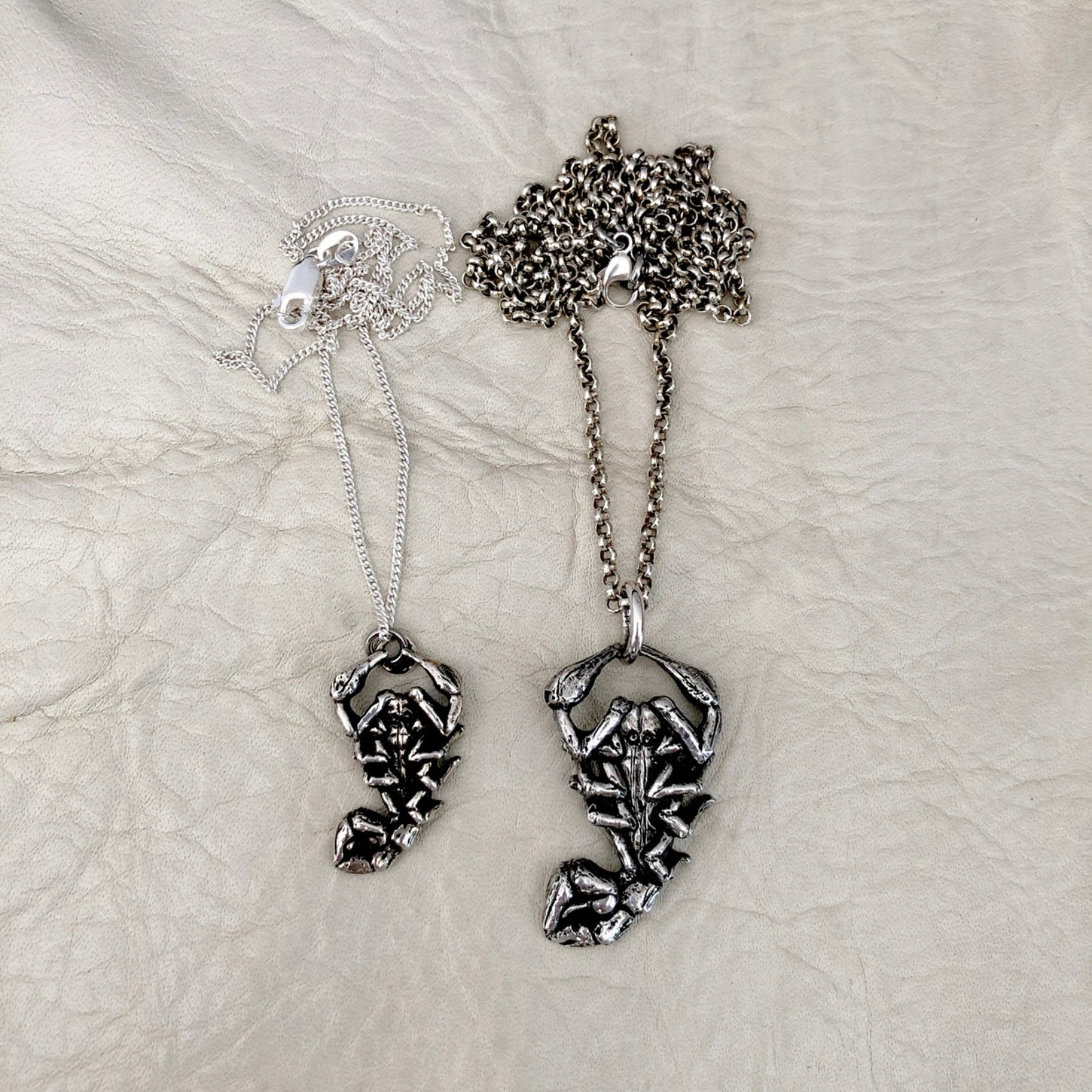 Intricate scorpion ring with detailed design, featuring a sleek matte look with a rounded smooth finish.