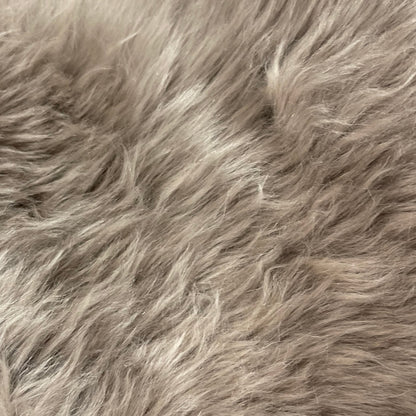 Soft and 100% natural sheepskin rug with natural, fluffy texture, showcasing premium quality craftsmanship and comfort for home decor.