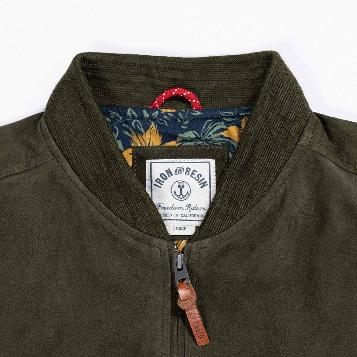 Close up of luxuriously soft goat suede bomber jacket with custom cotton poplin liner, two exterior side welt pockets for warmth, and vintage-inspired details for a classic look.