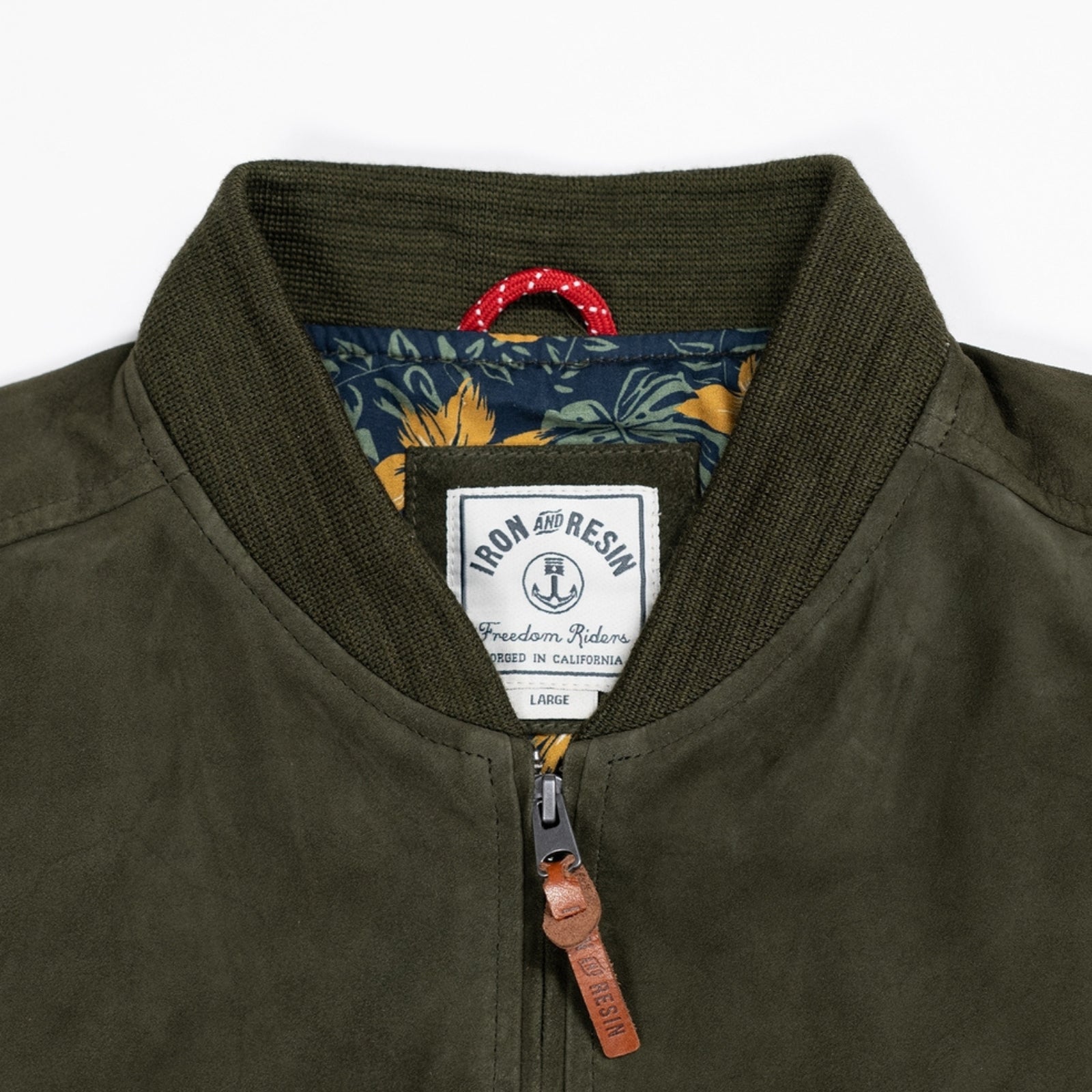 Close up of luxuriously soft goat suede bomber jacket with custom cotton poplin liner, two exterior side welt pockets for warmth, and vintage-inspired details for a classic look.