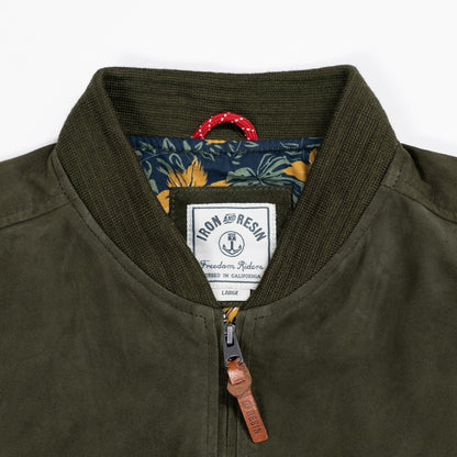 Close up of luxuriously soft goat suede bomber jacket with custom cotton poplin liner, two exterior side welt pockets for warmth, and vintage-inspired details for a classic look.