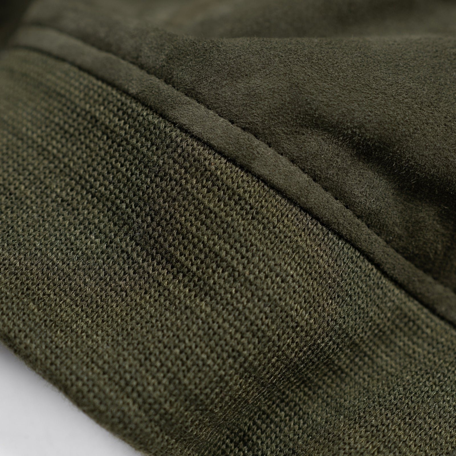 Close up of luxuriously soft goat suede bomber jacket with custom cotton poplin liner, two exterior side welt pockets for warmth, and vintage-inspired details for a classic look.