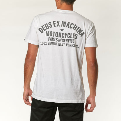 Classic white Deus Ex Machina t-shirt featuring the brand's iconic logo and bold design.
