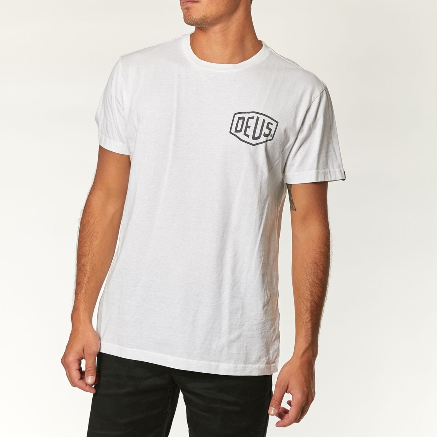 Classic white Deus Ex Machina t-shirt featuring the brand's iconic logo and bold design.
