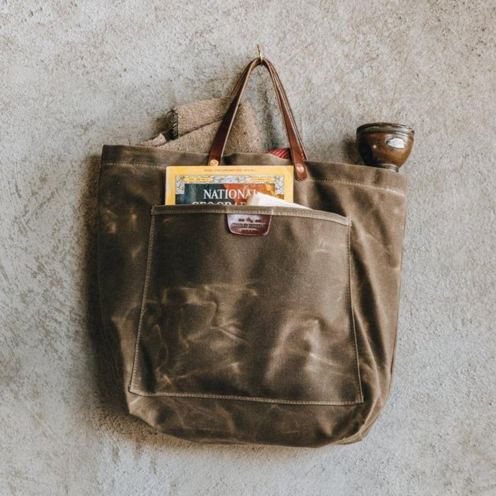 Sturdy waxed duck canvas tote bag with a rugged, featuring comfortable handles and a spacious interior for everyday use.