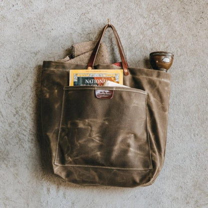 Sturdy waxed duck canvas tote bag with a rugged, featuring comfortable handles and a spacious interior for everyday use.