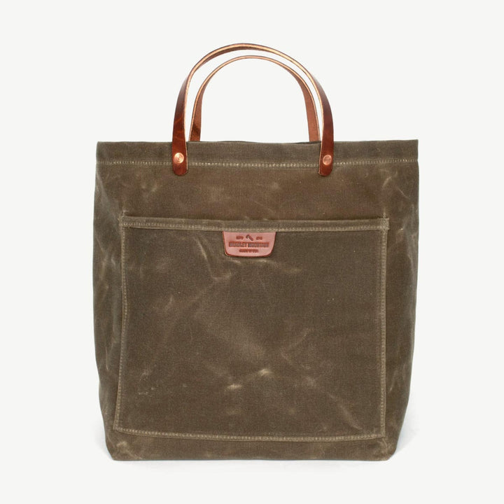 Sturdy waxed duck canvas tote bag with a rugged, featuring comfortable handles and a spacious interior for everyday use.