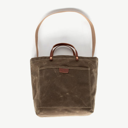 Sturdy waxed duck canvas tote bag with a rugged, featuring comfortable handles and a spacious interior for everyday use.
